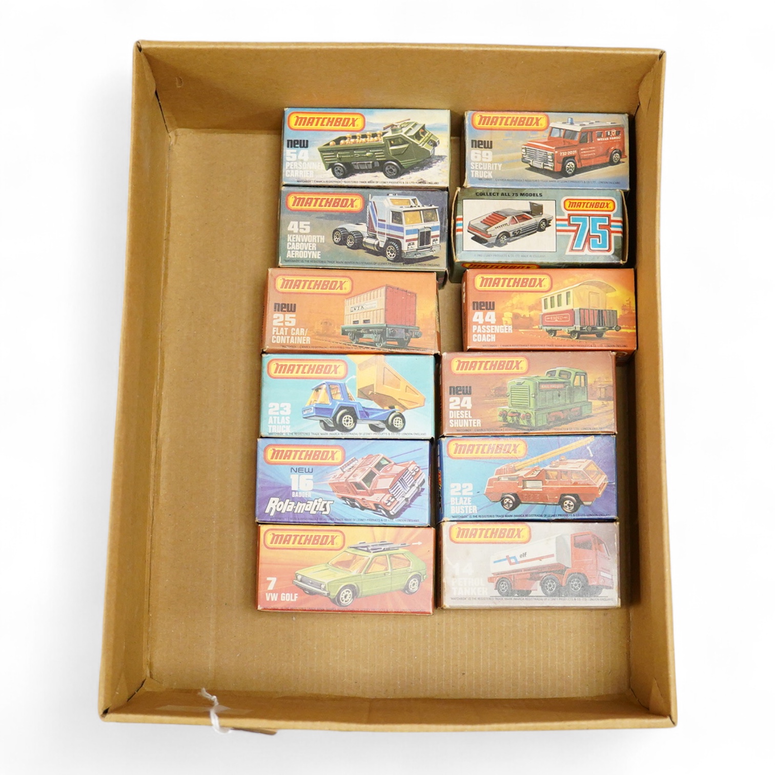 Twelve boxed Matchbox Superfast and Rola-matics 1-75 vehicles; VW Golf (7), petrol tanker (14), Badger (16), Blaze Buster (22), Atlas truck (23), diesel shunter (24), flat car with container (25), passenger coach (44), K